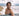 Young man on beach with surfboard