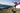man joyfully leaping on a mountain with a dog free of hypothyroidism